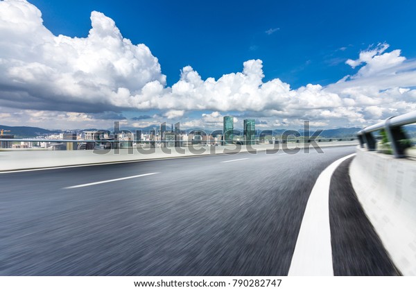Panoramic city\
skyline and buildings with empty\
road
