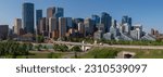 Panoramic city skyline in Calgary, Alberta during summer time with beautiful blue sky day Centre St Bridge in view. 