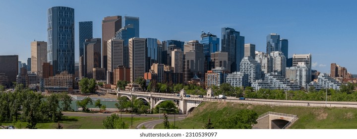Panoramic city skyline in Calgary, Alberta during summer time with beautiful blue sky day Centre St Bridge in view. 