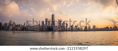 Panoramic city skyline of downtown Chicago from a boat in Lake Michigan at sunset 