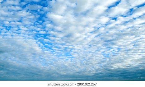 Panoramic cloudy sky background, sweeping sky landscape with picturesque cumulus clouds