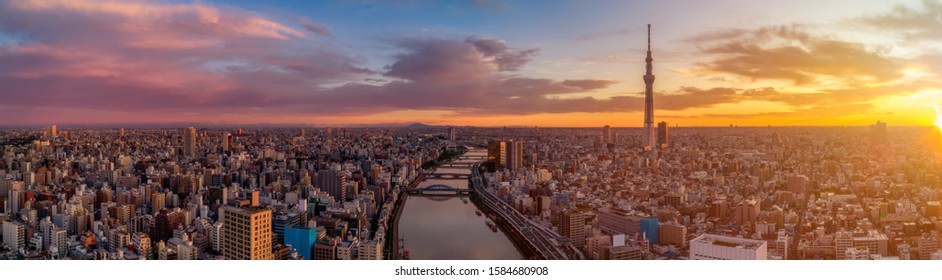 Panoramic Dawn view of Tokyo city. Famous Tokyo Skytree and Senso-Ji Temple with Sumida river. Colorful morning scene of Japan, Asia. Traveling concept background.

 - Shutterstock ID 1584680908