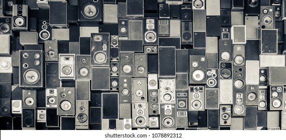 Panoramic detail view of speakers hanging on the wall in monochrome vintage style