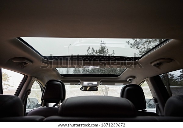 Panoramic\
double sunroof  in the interior of the\
car.