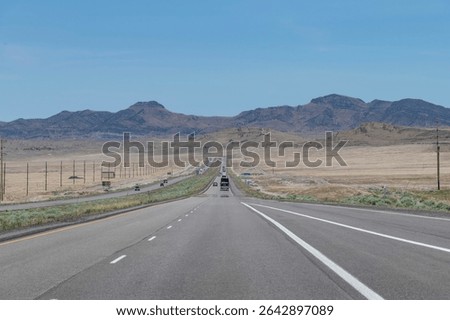 Panoramic drivers view over Interstate 80 or Dweight D Eisenhower Highway in the desert in Easterly direction from Salt Lake City, UT, USA to Wendover with mountain range on horizon