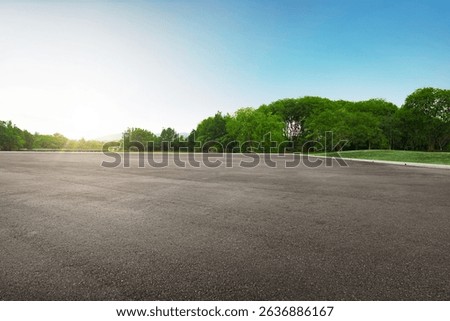 Panoramic empty tarmac floor at the comfortable beautiful green park under blue sky at morning.