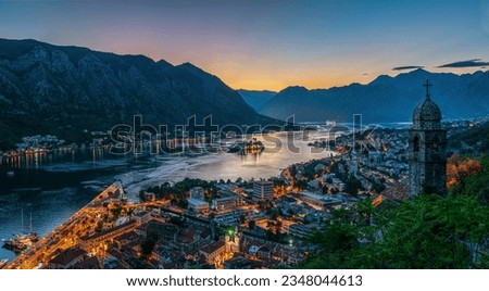 Panoramic evening view of the church, old town and the Bay of Kotor from above. The Bay of Kotor is the beautiful place on the Adriatic Sea. Kotor, Montenegro.