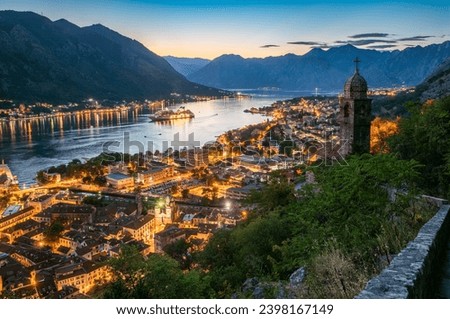 Panoramic evening view of the church, the old town and the Bay of Kotor from above. The Bay of Kotor is the beautiful place on the Adriatic Sea. Kotor, Montenegro.