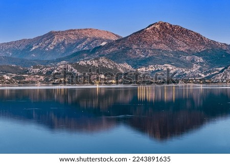 Panoramic evening view of Egirdir lake and town in Isparta region. Calm turquoise and scenic coast of national park in Turkey