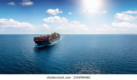 Panoramic front view of a cargo ship carrying containers for import and export, business logistic and transportation in open sea with copy space  - Shutterstock ID 2196984481