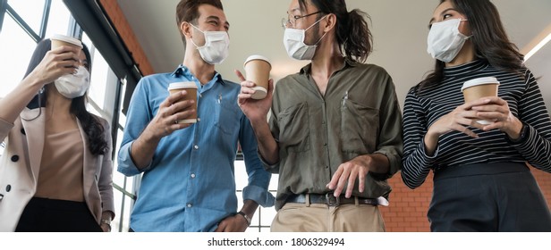 Panoramic group of business worker team with takeout coffee cup walking back to office after lunch break. They wear protective face mask in new normal office preventing coronavirus COVID-19 spreading. - Powered by Shutterstock