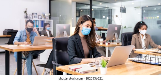 Panoramic group of business worker team wear protective face mask in new normal office with social distance practice with hand sanitiser alcohol gel on table prevent coronavirus COVID-19 spreading - Powered by Shutterstock