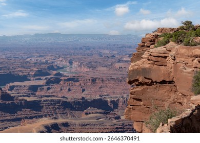 Panoramic high level view over the geological sandstone formations of Shafer Canyon within Canyonlands National Parkwith the Colorado River bending through landscape near Moab, Utah, USA