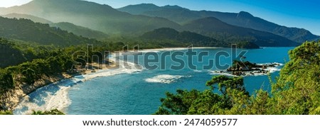 Panoramic image of Castelhanos beach between the sea, mountains and forests of the island of Ilhabela on the coast of Sao Paulo