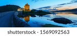 Panoramic image of Eilean Donan Castle is one of important attractions in the Scottish highlands , at the point where three great sea-lochs meet in sunset with reflection,  Kyle of Lochalsh , Scotland