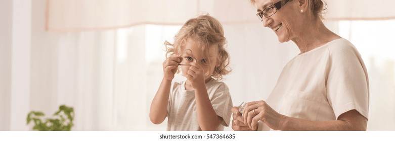 Panoramic Image Of Grandchild Holding A Cookie Cutter, Accompanied By Grandma