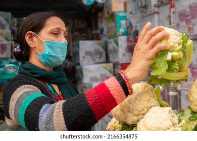 Panoramic Image Of Indian Mature Woman Wearing Protective Face Mask And Buying Fresh Green Vegetables From Outdoor Market During The Third Wave Of Coronavirus, COVID-19 Pandemic Outbreak In Indian.