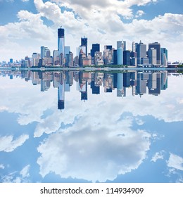 Panoramic image of lower Manhattan skyline with reflections.