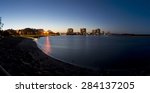 Panoramic image of Maroochydore at twilight just after sunset. Image taken from Cotton tree showing river bank, park and jetty on one side and sandy island on the other side. Queensland, Australia. 