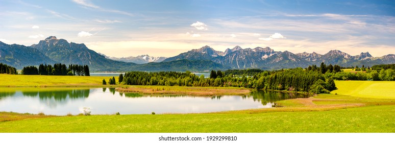 Panoramic Landscape In Bavaria With Mountain Range And Lake