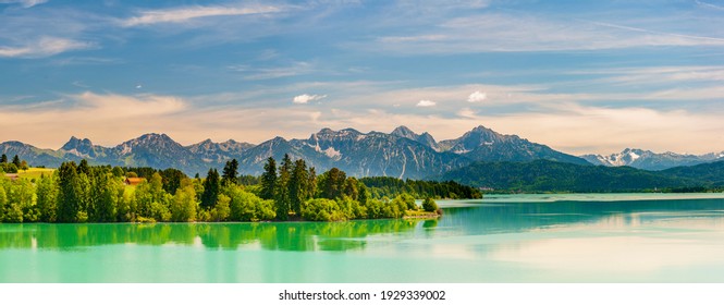 panoramic landscape in Bavaria with mountain range and lake