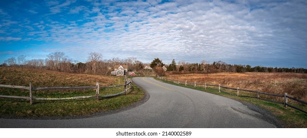 Panoramic Landscape And Cumulus Cloudscape Over The Meadow With Fences Along The Curved Coastal Road In New England, USA.