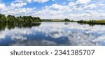 Panoramic landscape on blue summer lake.