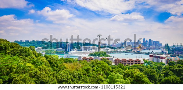 Panoramic\
landscape of Singapore port and cable cars. Cruise ship in the\
background. Viewpoint of Sentosa\
Island.