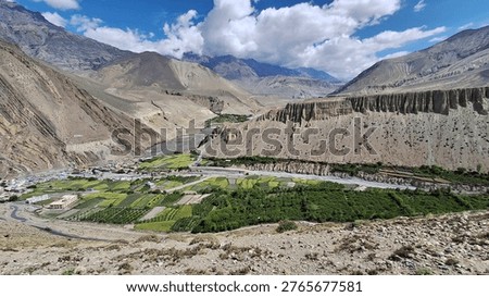 Panoramic landscape view of Jomsom (elevation 2,700m), the administrative 
headquarters of Mustang District, located along the banks of Kali Gandaki River — 
the world's deepest river gorge — in Gandaki Province, western Nepal. 
Flanked by Mt. Dhaulagiri (8,167m) to the west and Mt. Nilgiri to the south, 
the semi-arid high-altitude desert terrain contrasts dramatically with 
the turquoise river below. Jomsom serves as the gateway to Upper Mustang 
and the sacred Muktinath Temple (3,800m). Unique Thakali and Tibetan-influenced 
culture, prayer flags, whitewashed stone houses, and dramatic Himalayan backdrop 
