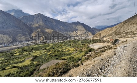 Panoramic landscape view of Jomsom (elevation 2,700m), the administrative 
headquarters of Mustang District, located along the banks of Kali Gandaki River — 
the world's deepest river gorge — in Gandaki Province, western Nepal. 
Flanked by Mt. Dhaulagiri (8,167m) to the west and Mt. Nilgiri to the south, 
the semi-arid high-altitude desert terrain contrasts dramatically with 
the turquoise river below. Jomsom serves as the gateway to Upper Mustang 
and the sacred Muktinath Temple (3,800m). Unique Thakali and Tibetan-influenced 
culture, prayer flags, whitewashed stone houses, and dramatic Himalayan backdrop 
