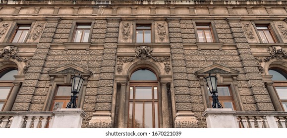 panoramic medieval European palace architecture building stone exterior facade foreshortening travel photography from below on gray brown wall with big windows and arch door entrance  - Shutterstock ID 1670221039