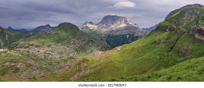 Panoramic Mountain Landscape With Rocky Mountain Peaks In Dark Clouds. Lonely Panoramic Landscape In The Alps.