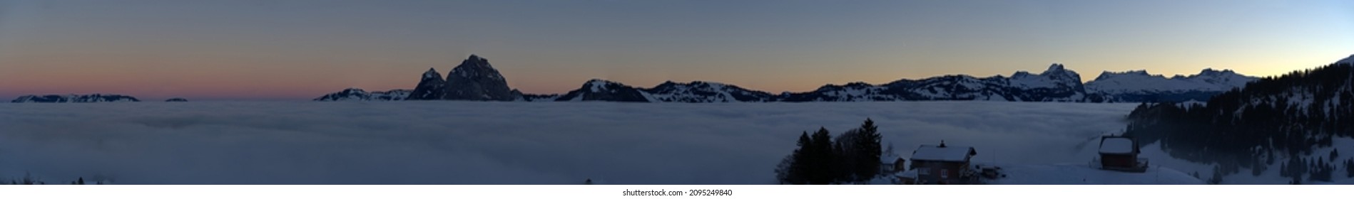 Panoramic mountain view seen from mountain village Stoos, Canton Schwyz, on a beautiful winter morning with sea of fog in the foreground. Photo taken December 21st, 2021, Stoos, Switzerland. 