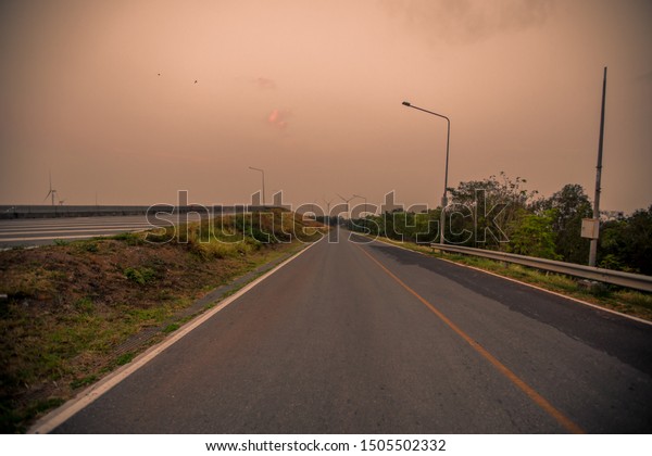 The\
panoramic natural background of the natural scenery in the evening\
on the road while traveling, with a blurred\
breeze.