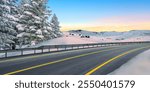 Panoramic nature road landscape in snowy mountain in winter season. Snow winter road scenery in europe trip. Winter travel in mountain highway view. Winter landscape on sunset in snowy nature panorama