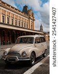 panoramic, old car parked on the street, station wagon type, 60s, in the background, Luz station, historic building in São Paulo