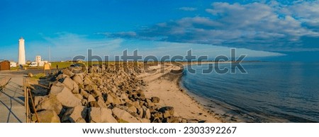 Panoramic over old lighthouse Gardur at seashore of Iceland at sunset colors and blue sky