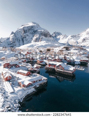 Panoramic overview of the small fishing village of A (Moskenes) at the end of the road of the Lofoten islands archipelago in northern Norway - Red rorbuer on stilts in winter at dawn in a fjord Stock photo © 
