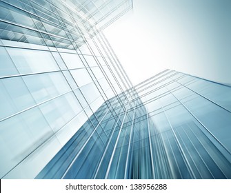 Panoramic And Perspective Wide Angle View To Steel Blue Background Of Glass High Rise Building Skyscrapers In Modern Futuristic Downtown At Night Business Concept Of Successful Industrial Architecture