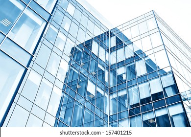 Panoramic And Perspective Wide Angle View To Steel Blue Background Of Glass High Rise Building Skyscrapers In Modern Futuristic Downtown At Night Business Concept Of Successful Industrial Architecture