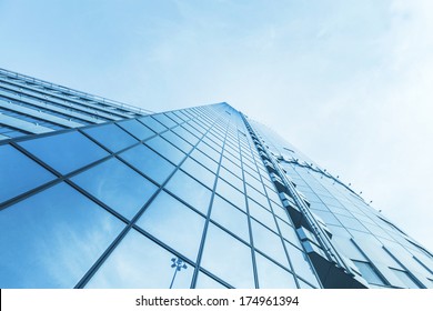 Panoramic And Perspective Wide Angle View To Steel Blue Background Of Glass High Rise Building Skyscrapers In Modern Futuristic Downtown At Night Business Concept Of Successful Industrial Architecture