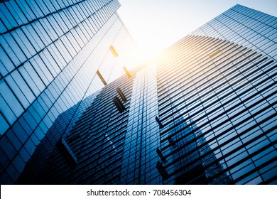 Panoramic And Perspective Wide Angle View To Steel Light Blue Background Of Glass High Rise Building Skyscraper Commercial Modern City Of Future. Business Concept Of Success Industry Tech Architecture