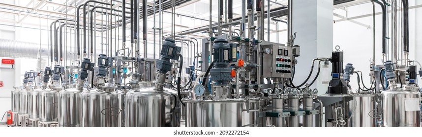 Panoramic photo of pipes and tanks. Chemistry and medicine production. Pharmaceutical factory. Interior of a high-tech factory, modern production