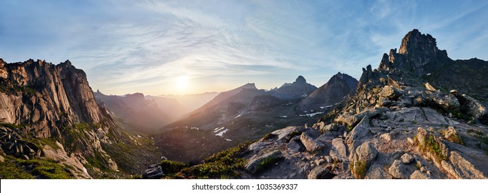 Panoramic photo of the spring mountain valley natural Park Ergaki, Russia. Fabulous sunrise and sunset in the mountains, amazing nature, spring in the mountains. Travel and hike