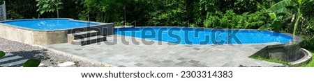 Panoramic photo of swimming pool with clear blue water