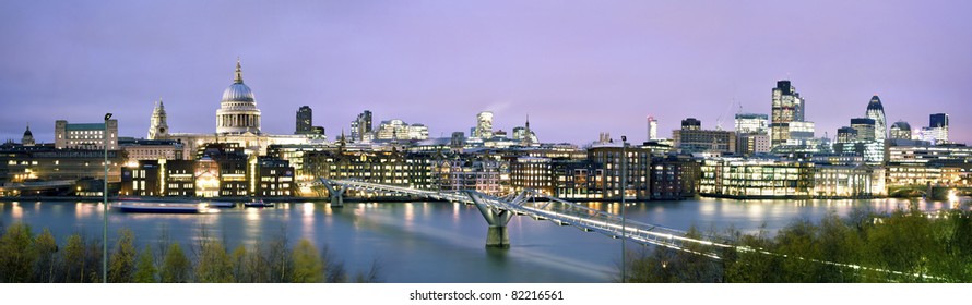 Panoramic picture of St. Paul's Cathedral, Millennium Bridge and  the Financial District at twilight.