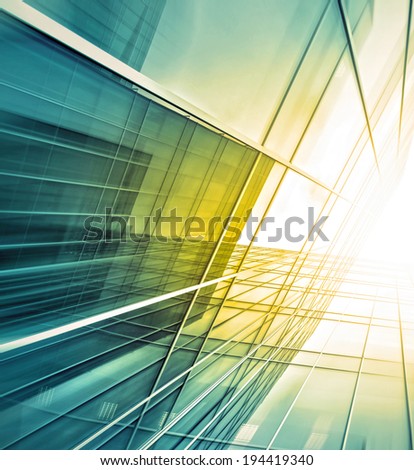 Panoramic and prospective wide angle view to steel light blue background of glass high rise building skyscraper commercial modern city of future. Business concept of successful industrial architecture
