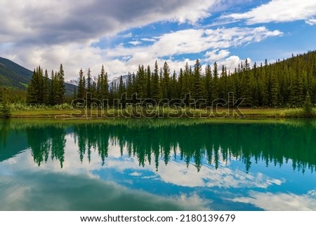 Panoramic reflections on a Banff park lake
