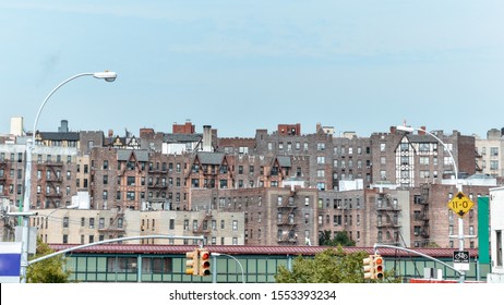 Panoramic roof view of old houses. Brick buildings with fire stairs during the day. Travel and housing concepts. Bronx, NYC, USA.
