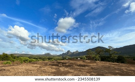 A panoramic scenery of the mountains from the arid field